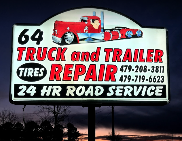 Sign at night in front of truck repair shop